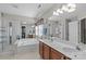 Bright bathroom features a glass-enclosed shower, soaking tub, and double sink vanity with wood cabinets at 3831 Robeson Creek Dr, Charlotte, NC 28270
