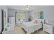Bright bedroom with white furniture, including a bed, nightstand, dresser, desk, and a window for natural light at 3831 Robeson Creek Dr, Charlotte, NC 28270