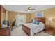 Well-lit bedroom with a wooden bed frame, a desk, and a window providing natural light at 3831 Robeson Creek Dr, Charlotte, NC 28270