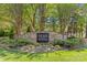 Stone community sign for McKee Woods surrounded by lush greenery at 3831 Robeson Creek Dr, Charlotte, NC 28270