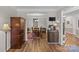 Open-concept entryway with hardwood floors leading to dining area, showcasing a functional and stylish design at 3831 Robeson Creek Dr, Charlotte, NC 28270