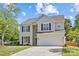 Charming two-story home with a well-maintained lawn, two car garage, and classic architectural details at 3831 Robeson Creek Dr, Charlotte, NC 28270