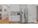 Modern kitchen with white cabinets, stainless steel refrigerator, granite countertops, and tile backsplash at 3831 Robeson Creek Dr, Charlotte, NC 28270