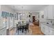 Open concept kitchen with eat-in area, hardwood floors, and view of the cozy living room fireplace at 3831 Robeson Creek Dr, Charlotte, NC 28270