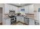 Well-equipped kitchen with stainless steel appliances, granite countertops, and white cabinetry at 3831 Robeson Creek Dr, Charlotte, NC 28270