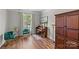 Cozy living room featuring hardwood floors, piano, natural light, and elegant decor creating a welcoming space at 3831 Robeson Creek Dr, Charlotte, NC 28270