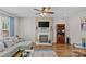 Cozy living room with fireplace, built-in shelving, hardwood floors and a comfortable sectional sofa at 3831 Robeson Creek Dr, Charlotte, NC 28270