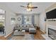 Comfortable living room with a gray sectional sofa, hardwood floors, and large bright windows at 3831 Robeson Creek Dr, Charlotte, NC 28270