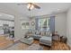 Inviting living room featuring a gray sectional sofa, hardwood floors, and large windows at 3831 Robeson Creek Dr, Charlotte, NC 28270