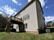The back of the house with a deck, a yard with sparse grass, and blue skies overhead at 3914 Cassidy Dr, Waxhaw, NC 28173