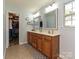 Large bathroom with double vanity, walk-in closet, and tiled flooring at 3914 Cassidy Dr, Waxhaw, NC 28173