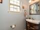 Bathroom with decorative mirror, lighting, and wood vanity with sink at 3914 Cassidy Dr, Waxhaw, NC 28173