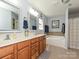 Bathroom featuring double sink vanity, framed mirrors, lighting fixtures, and a bathtub at 3914 Cassidy Dr, Waxhaw, NC 28173