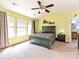 Spacious bedroom with carpet, ceiling fan, en-suite bathroom, and ample natural light at 3914 Cassidy Dr, Waxhaw, NC 28173