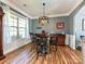 Stylish dining area with modern lighting, gray walls, a round table with seating, and wood floors at 3914 Cassidy Dr, Waxhaw, NC 28173