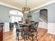 Open dining area with a rustic table, archway views to the living room and staircase at 3914 Cassidy Dr, Waxhaw, NC 28173