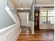 Elegant foyer with hardwood floors, staircase, grandfather clock, and a view of the front door at 3914 Cassidy Dr, Waxhaw, NC 28173