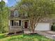 Charming brick home featuring an inviting front porch, well-maintained landscaping, and a two-car garage at 3914 Cassidy Dr, Waxhaw, NC 28173