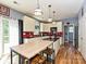 The kitchen features modern appliances, a red backsplash, and a breakfast bar with stools at 3914 Cassidy Dr, Waxhaw, NC 28173