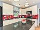 Modern kitchen with stainless appliances, red backsplash, and large island with a breakfast bar at 3914 Cassidy Dr, Waxhaw, NC 28173