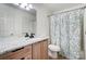 Bathroom with granite countertop, tile floor, and shower with floral shower curtain at 4036 Windward Dr, Tega Cay, SC 29708