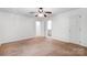 Bright bedroom features a ceiling fan, natural light and light brown carpet at 4036 Windward Dr, Tega Cay, SC 29708