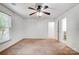 Bright bedroom features a ceiling fan, natural light and light brown carpet at 4036 Windward Dr, Tega Cay, SC 29708
