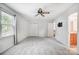 Well-lit bedroom with carpet flooring, ceiling fan and closets at 4036 Windward Dr, Tega Cay, SC 29708
