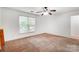 Bright bedroom features a ceiling fan, natural light and light brown carpet at 4036 Windward Dr, Tega Cay, SC 29708