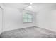 Spacious bedroom with a ceiling fan, neutral walls, and a window for natural light at 4036 Windward Dr, Tega Cay, SC 29708