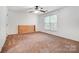 Bright bedroom features a ceiling fan, natural light and light brown carpet at 4036 Windward Dr, Tega Cay, SC 29708