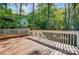 An inviting wooden deck with white railings offers a serene outdoor living space amidst lush greenery at 4036 Windward Dr, Tega Cay, SC 29708