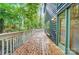 Large deck with wooden flooring surrounded by mature trees and a view of the backyard at 4036 Windward Dr, Tega Cay, SC 29708