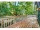 Private wooden deck surrounded by mature trees offering privacy and outdoor living space at 4036 Windward Dr, Tega Cay, SC 29708