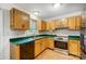 Kitchen with wooden cabinets, stainless steel appliances, and a bright window at 4036 Windward Dr, Tega Cay, SC 29708