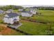 Wide shot of the fenced backyard featuring a wooden deck, landscaping, and a large grassy area at 4040 Lauren Elizabeth Dr, Rock Hill, SC 29732