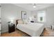 Bright bedroom with white bedding, contemporary decor, and natural light, creating a relaxing atmosphere at 4040 Lauren Elizabeth Dr, Rock Hill, SC 29732