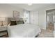 Comfortable bedroom featuring a tufted headboard, neutral decor, and a view into the hallway at 4040 Lauren Elizabeth Dr, Rock Hill, SC 29732