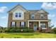 Charming two-story brick home featuring a welcoming front porch and well-maintained landscaping at 4040 Lauren Elizabeth Dr, Rock Hill, SC 29732