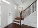 Foyer with hardwood floors, staircase with wrought iron details, and white paneled walls at 4040 Lauren Elizabeth Dr, Rock Hill, SC 29732