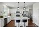 Modern kitchen features white cabinets, stainless steel appliances, and a quartz island with bar seating at 4040 Lauren Elizabeth Dr, Rock Hill, SC 29732