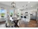 Modern kitchen features stainless steel appliances, a center island, and an adjacent dining area at 4040 Lauren Elizabeth Dr, Rock Hill, SC 29732