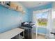 Functional laundry room with modern washer and dryer, ample shelving, and a bright window offering a view at 4040 Lauren Elizabeth Dr, Rock Hill, SC 29732