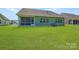Home with a green backyard and screened-in porch with windows to the interior at 4110 Camden Glen Rd, Lancaster, SC 29720