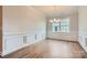 Formal dining room with elegant wainscoting, wood floors, and a stylish chandelier at 4110 Camden Glen Rd, Lancaster, SC 29720