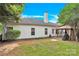Backyard with a covered patio, a grassy area, mature trees, and partial home view at 4155 Guilford Nw Ct, Concord, NC 28027