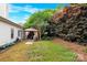 Backyard with a covered patio, a grassy area, and mature trees at 4155 Guilford Nw Ct, Concord, NC 28027