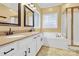 Bright bathroom featuring a double vanity, modern fixtures, and a tiled shower at 4155 Guilford Nw Ct, Concord, NC 28027
