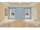 Bright bedroom with tray ceiling, carpet flooring, built-in shelving, and ample natural light at 4155 Guilford Nw Ct, Concord, NC 28027