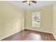 Bedroom with hardwood floors, a bright window, and neutral colored walls at 4155 Guilford Nw Ct, Concord, NC 28027